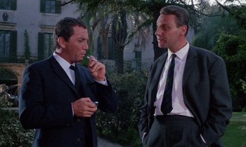 Movie still from “Blood and Black Lace” (1964), directed by Mario Bava – Two men in business suits standing next to each other; Medium shot, Low angle