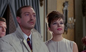 Movie still from “Blood and Black Lace” (1964), directed by Mario Bava – A man and a woman standing next to each other; Close Up shot, Low angle