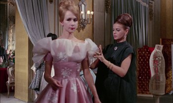 Movie still from “Blood and Black Lace” (1964), directed by Mario Bava – A woman in a pink dress is looking at a woman in a black dress; Medium shot, Low angle