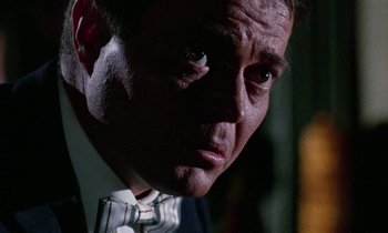 Movie still from “Blood and Black Lace” (1964), directed by Mario Bava – A person wearing a suit and tie; Close Up shot, Low angle
