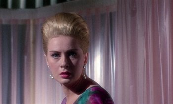 Movie still from “Blood and Black Lace” (1964), directed by Mario Bava – A woman in a colorful dress with a high ponytail; Close Up shot, Low angle