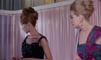 Movie still from “Blood and Black Lace” (1964), directed by Mario Bava – Two beautiful women in black and pink dresses; Medium shot, Low angle
