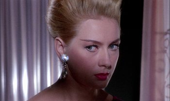 Movie still from “Blood and Black Lace” (1964), directed by Mario Bava – A beautiful woman with blonde hair and blue eyes; Close Up shot, Over the shoulder angle