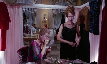 Movie still from “Blood and Black Lace” (1964), directed by Mario Bava – Two women are looking in a mirror in a restaurant; Medium shot, Over the shoulder angle
