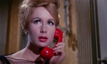 Movie still from “Blood and Black Lace” (1964), directed by Mario Bava – A beautiful woman holding a red phone up to her ear; Close Up shot, Low angle