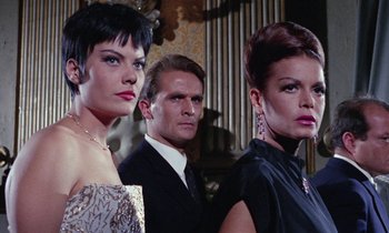 Movie still from “Blood and Black Lace” (1964), directed by Mario Bava – A group of people standing next to each other in a room; Close Up shot, Low angle