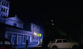 Movie still from “Blood and Black Lace” (1964), directed by Mario Bava – Two people walking down a street at night; Extreme Wide shot, Low angle