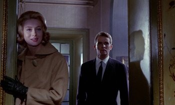 Movie still from “Blood and Black Lace” (1964), directed by Mario Bava – A man and a woman standing in front of each other; Medium shot, Low angle