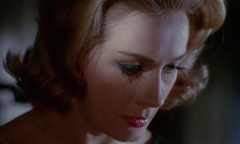 Movie still from “Blood and Black Lace” (1964), directed by Mario Bava – A woman's face with blue eye shadow; Close Up shot, High angle