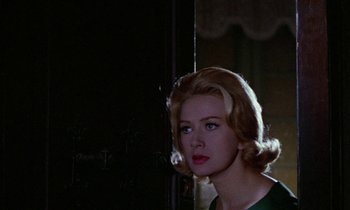 Movie still from “Blood and Black Lace” (1964), directed by Mario Bava – A woman with blonde curly hair and a green dress; Close Up shot, Low angle