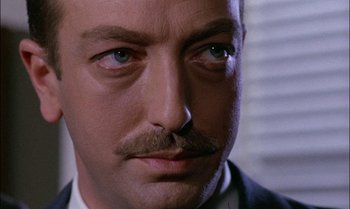 Movie still from “Blood and Black Lace” (1964), directed by Mario Bava – A person with a mustache; Close Up shot, Low angle