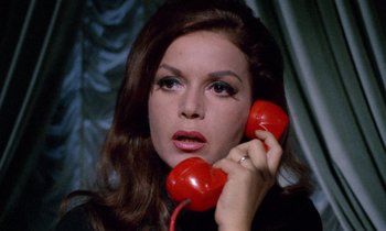Movie still from “Blood and Black Lace” (1964), directed by Mario Bava – A woman holding a phone up to her ear; Close Up shot, High angle