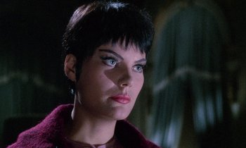 Movie still from “Blood and Black Lace” (1964), directed by Mario Bava – A person with short black hair; Close Up shot, Low angle