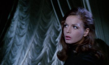 Movie still from “Blood and Black Lace” (1964), directed by Mario Bava – A beautiful woman standing in front of a wall; Close Up shot, Over the shoulder angle