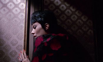 Movie still from “Blood and Black Lace” (1964), directed by Mario Bava – A woman with short black hair wearing a black and red shawl; Close Up shot, Low angle