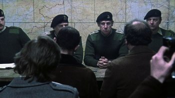 Movie still from “Bloody Sunday” (2002), directed by Paul Greengrass – A group of people sitting around a table; Medium shot, Over the shoulder angle