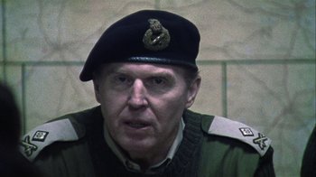 Movie still from “Bloody Sunday” (2002), directed by Paul Greengrass – An older man wearing a military uniform and wearing a hat; Close Up shot, Over the shoulder angle