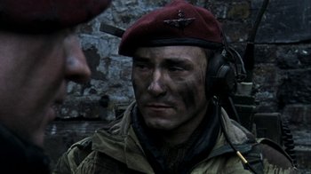 Movie still from “Bloody Sunday” (2002), directed by Paul Greengrass – A man in a military uniform with a red hat; Close Up shot, Over the shoulder angle