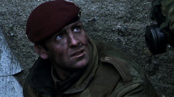 Movie still from “Bloody Sunday” (2002), directed by Paul Greengrass – A man wearing a military uniform and a maroon beret; Close Up shot, High angle