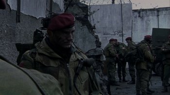 Movie still from “Bloody Sunday” (2002), directed by Paul Greengrass – A group of men standing next to each other on a street; Medium shot, Over the shoulder angle