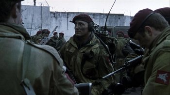 Movie still from “Bloody Sunday” (2002), directed by Paul Greengrass – A group of men in military fatigues with guns; Medium shot, Low angle