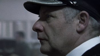 Movie still from “Bloody Sunday” (2002), directed by Paul Greengrass – A person wearing a hat; Close Up shot, Low angle