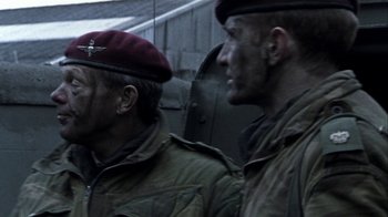 Movie still from “Bloody Sunday” (2002), directed by Paul Greengrass – Two men in military fatigues are standing next to each other; Close Up shot, Over the shoulder angle