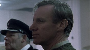 Movie still from “Bloody Sunday” (2002), directed by Paul Greengrass – A person wearing a suit and tie; Close Up shot, Low angle