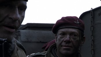 Movie still from “Bloody Sunday” (2002), directed by Paul Greengrass – A man wearing a maroon hat and a brown jacket; Close Up shot, Low angle