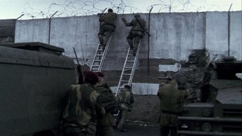 Movie still from “Bloody Sunday” (2002), directed by Paul Greengrass – A group of men climbing a wall with ladders; Wide shot, Low angle