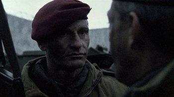A man wearing a red hat and a jacket