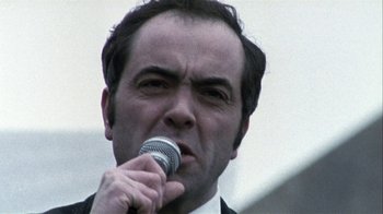 Movie still from “Bloody Sunday” (2002), directed by Paul Greengrass – A person holding a microphone; Close Up shot, Low angle
