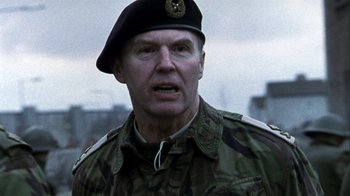 Movie still from “Bloody Sunday” (2002), directed by Paul Greengrass – A man in a military uniform with a hat on; Close Up shot, Low angle