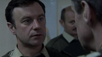 Movie still from “Bloody Sunday” (2002), directed by Paul Greengrass – A man looking at himself in the mirror; Close Up shot, Over the shoulder angle
