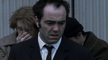 Movie still from “Bloody Sunday” (2002), directed by Paul Greengrass – A person wearing a suit and a tie; Close Up shot, Low angle