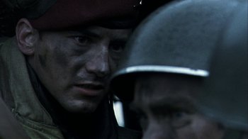 Movie still from “Bloody Sunday” (2002), directed by Paul Greengrass – A person wearing a hat; Close Up shot, Over the shoulder angle