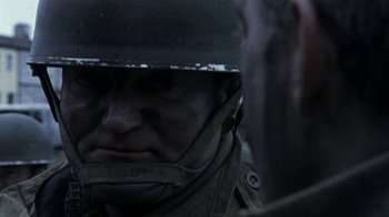 Movie still from “Bloody Sunday” (2002), directed by Paul Greengrass – A person wearing a helmet; Close Up shot, Over the shoulder angle