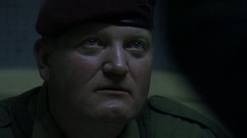 Movie still from “Bloody Sunday” (2002), directed by Paul Greengrass – A person wearing a uniform; Close Up shot, Over the shoulder angle