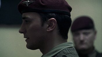 Movie still from “Bloody Sunday” (2002), directed by Paul Greengrass – A person wearing a hat; Close Up shot, Over the shoulder angle