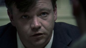 Movie still from “Bloody Sunday” (2002), directed by Paul Greengrass – A person wearing a suit and tie; Close Up shot, Over the shoulder angle
