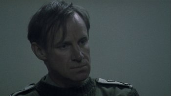 Movie still from “Bloody Sunday” (2002), directed by Paul Greengrass – A person wearing a uniform; Close Up shot, Over the shoulder angle