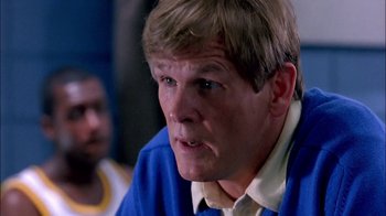 Movie still from “Blue Chips” (1994), directed by William Friedkin – A person wearing a blue shirt; Close Up shot, Low angle