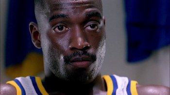 Movie still from “Blue Chips” (1994), directed by William Friedkin – A man's face in a room; Close Up shot, Low angle