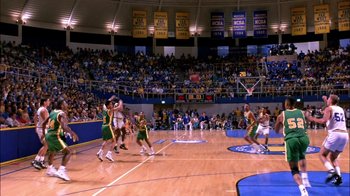 Movie still from “Blue Chips” (1994), directed by William Friedkin – A group of men playing a game of basketball on an indoor court; Extreme Wide shot, Overhead angle