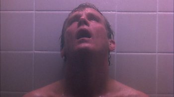 Movie still from “Blue Chips” (1994), directed by William Friedkin – A man is taking a shower in the bathroom; Close Up shot, Low angle
