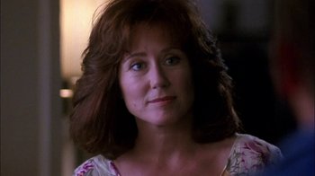 Movie still from “Blue Chips” (1994), directed by William Friedkin – A person with long brown hair; Close Up shot, Low angle