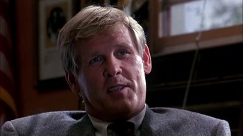 Movie still from “Blue Chips” (1994), directed by William Friedkin – A person wearing a suit and tie; Close Up shot, Low angle