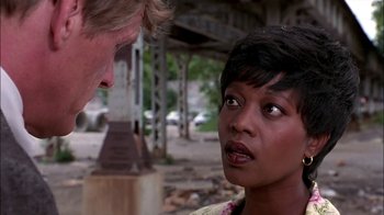 Movie still from “Blue Chips” (1994), directed by William Friedkin – A man and a woman are talking in the street; Close Up shot, Over the shoulder angle