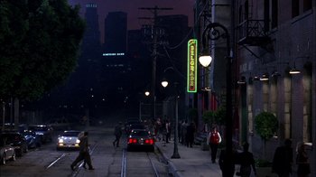 Movie still from “Blue Chips” (1994), directed by William Friedkin – A group of people walking down a street at night; Extreme Wide shot, High angle