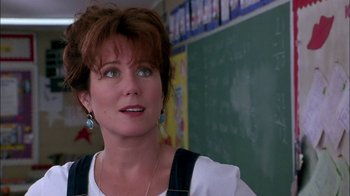 Movie still from “Blue Chips” (1994), directed by William Friedkin – A woman standing in front of a chalkboard; Close Up shot, Low angle
